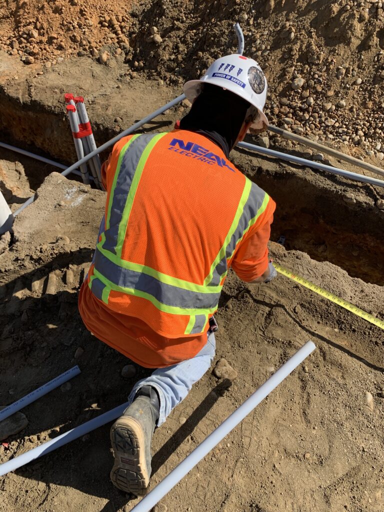 Neal Electric worker on the field