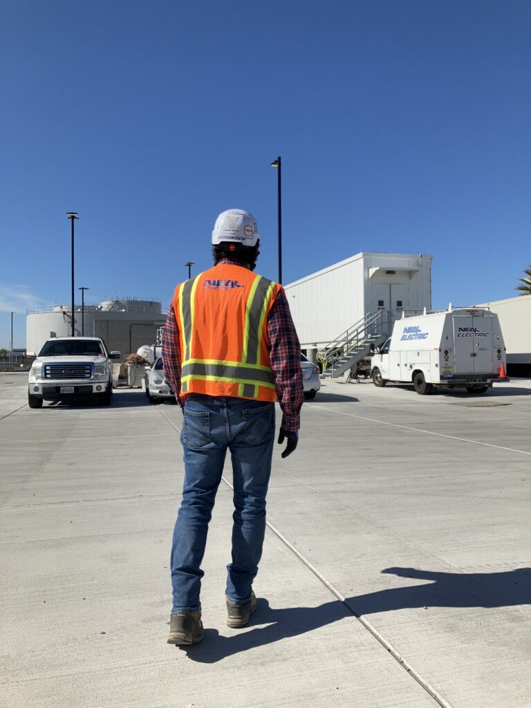 Neal Electric worker walking on the field